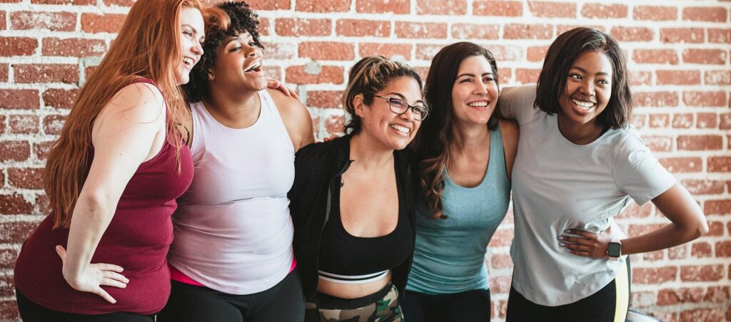 Group of ladies at the gym supporting each other as part of a weight loss community, stressing importance of community if taking GLP-1 medications like Ozempic, Wegovy, Saxenda, Mounjaro, etc.