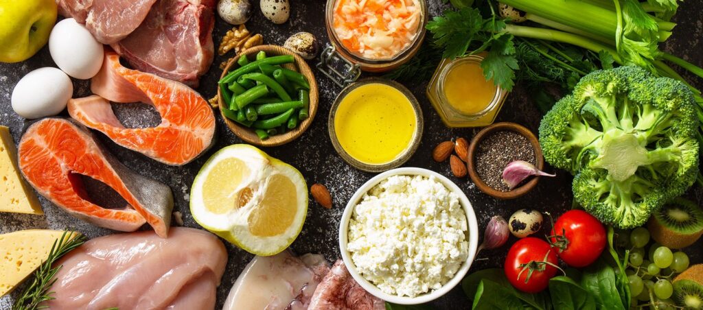 Table full of high protein food sources stressing the importance of high protein diets for patients taking GLP-1 medical weight loss prescriptions like Ozempic, Wegovy, Mounjaro, Saxenda, and more.