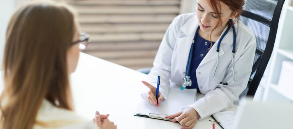 Obesity medicine doctor writes a GLP-1 prescription in her office for patient needing support with medical weight loss and diabetes management