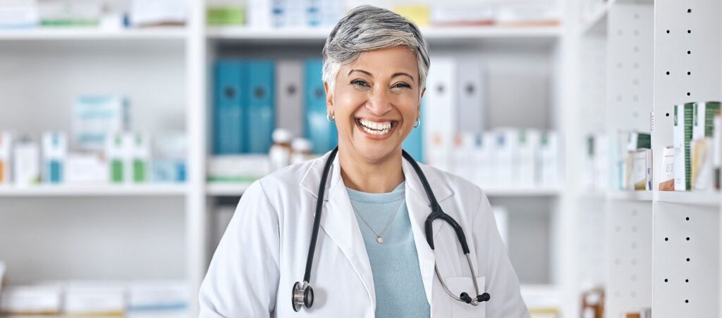 Obesity medicine provider stands in a pharmacy setting explaining benefits of GLP-1 prescriptions to patients for weight loss and diabetes management
